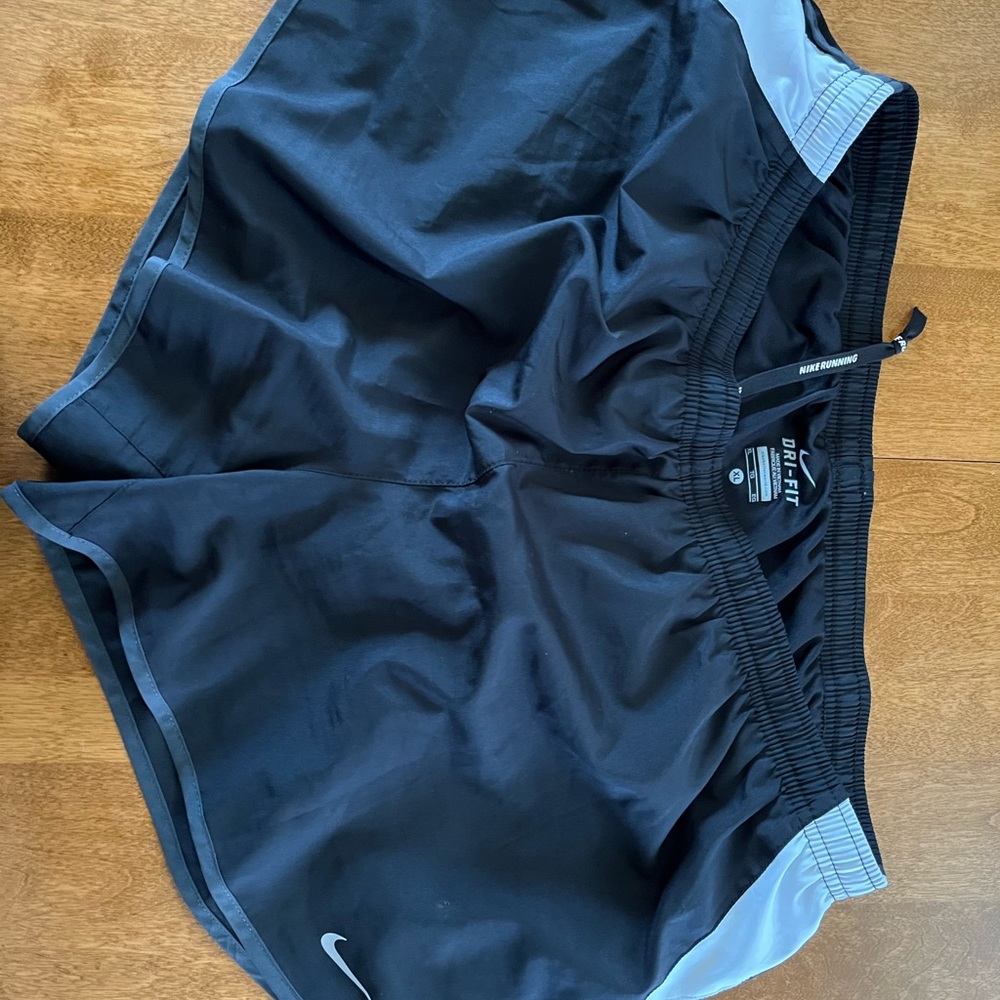 XL black with white side panels Nike Dri-Fit women’s running shorts.